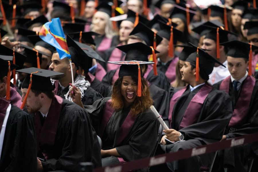 Marie-Esperanoce Namage Baseleba waves the Democratic Republic of Congos flag to her family on Saturday, May 11, 2019 during the 2019 commencement inside the SIU Arena.  Baseleba, from the Democratic Republic of Congo, received her degree in Computer Engineering.