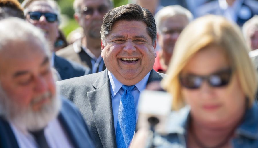 Illinois Governor Pritzker smiles while owners of Walkers Bluff Cynde and David Bunch speak on Tuesday, July 2, 2019 at Walkers Bluff in Carterville, Illinois. Governor Pritzker announced that Walkers Bluff will be receiving its casino license for the Walkers Bluff resort expansion. Pritzker says that Illinois is investing 45 million over six years for his plan Rebuild Illinois. Pritzker says that his plan will repair whats broken and build whats needed.