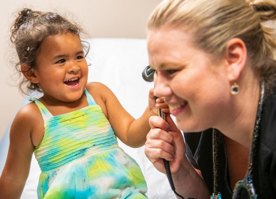 Tia Faye Morrison-Meade, of Carbondale, checks Samantha Christopher ears on Tuesday, July 13, 2019 during Shawnee Health Cares Back-to-School Exams in Carbondale, Illinois. Over 100 children were either given physicals, vision screenings, and immunizations. Shawnee Health Care will be having another back-to-school exam services on Thursday in Marion. Christopher, of Marion, hopes that the turn out will prompt more back-to-school events. 