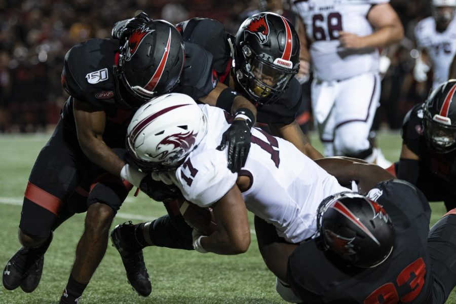 Saluki junior wide receiver Landon Lenoi gets tackled by multiple Redhawks on Aug. 29, 2019, during the Salukis 26-44 loss against the Southeast Missouri State Redhawks  at the Houck Stadium in Cape Giradeau, Missouri. 