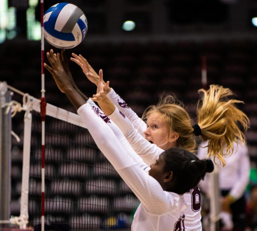 Salukis Hannah Becker and Savannah Sheridan attempt to block the ball on Saturday, Sept. 7, 2019 during the Salukis’ 3-1 win against the Southeastern Louisiana University Lions at the Banterra Center. 