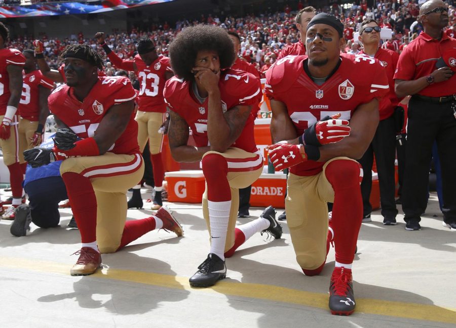 From left, The San Francisco 49's Eli Harold (58), Colin Kaepernick (7) and Eric Reid (35) kneel during the national anthem before their a game against the Dallas Cowboys on October 2, 2016, at Levi's Stadium in Santa Clara, Calif. Photo courtesy of Nhat V. Meyer/Bay Area News Group/TNS. 