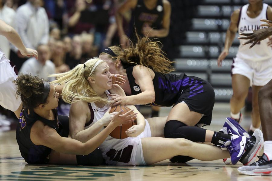 Saluki guard Caitlin Link wrestles for the ball on Friday, January 10, 2020, during the Salukis 60-57 loss to the Northern Iowa Panthers inside the Banterra Center.