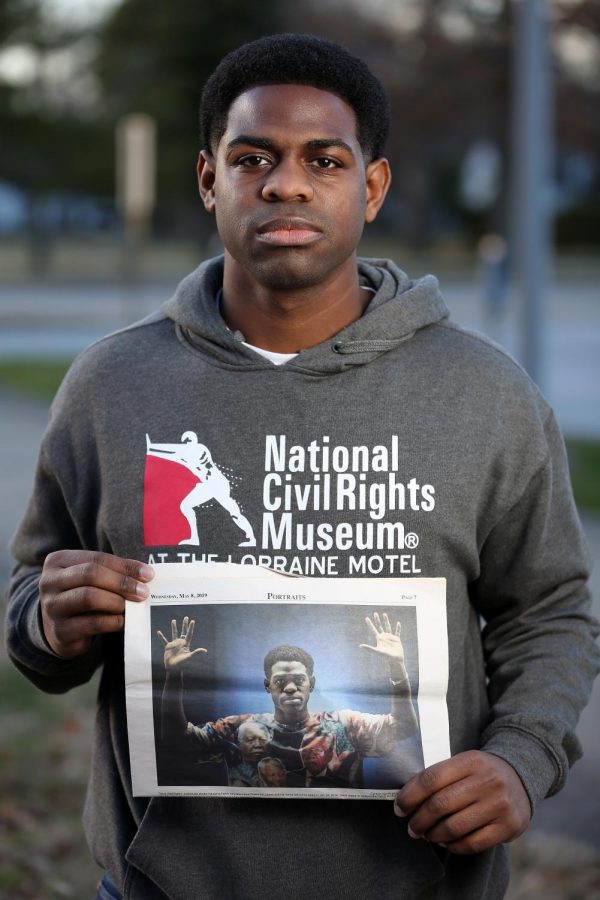Travis Washington of Flossmoor, IL holds a Daily Egyptian news article, which ran on 02/06/19 and featured Washington, on the SIU campus on Saturday, January 18, 2020, Carbondale, Illinois.  Washington, 25, graduated with his MA degree in Education Administration last May from the SIU graduate program, and has been the force behind the Hands Up Act, a piece of legislation that would make it illegal for police officers to shoot someone if the person is found to be unarmed.