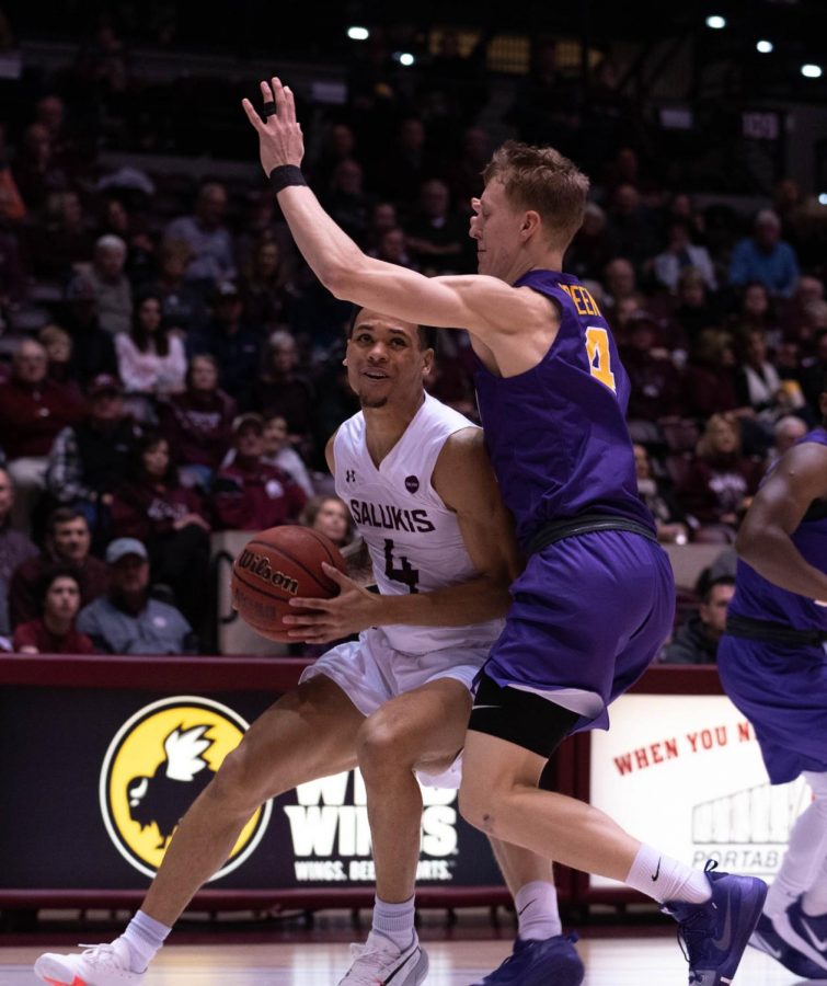 Southern Illinois Universitys Senior guard Eric McGill protects the ball from University of Nothern Iowas Sophmore guard AJ Green during the Wednesday January 22, 2020 game in SIUs Bantera Arena. The game ended at 68 SIU and 66 UNI.