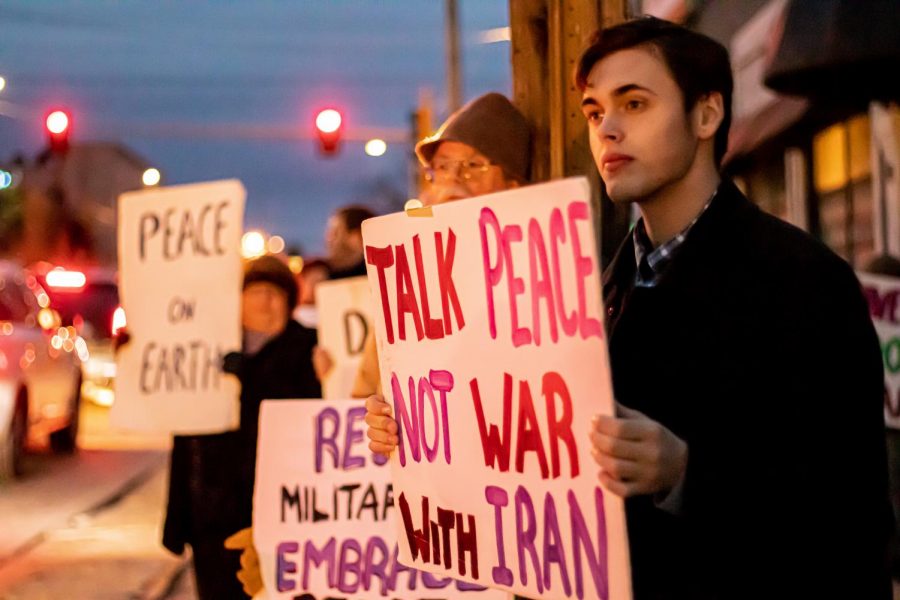Max Pernitsky shows his support by holding a sign at the No War Rally held in downtown Carbondale, Il on Thursday, Jan. 9, 2020.