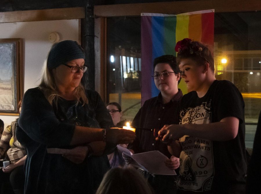 Cassandra Bolte, of Highland, lights a candle for Janie Turck, of Collinsville, during the Imbolc ceremony on Saturday, Feb. 1 at the Gaia House in Carbondale.