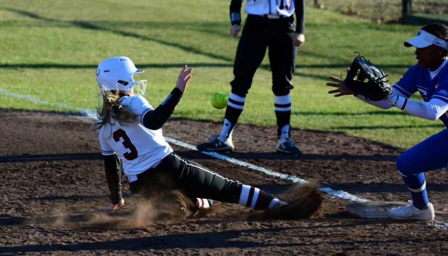 Susie Baranski slides back into first base, Saturday, February 29, 2020 during the Salukis 4-3 win against the Creighton at Charlotte West Stadium.