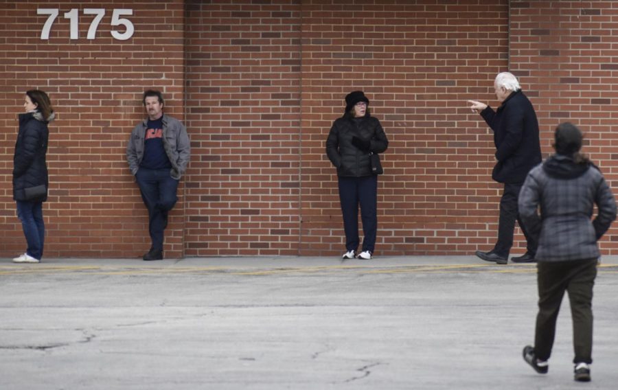 Customers at Binny’s Beverage Depot practice social distancing while waiting to enter the store on March 20 in Lincolnwood, Illinois. The CDC recommends staying at least 6 feet away from other people in public places.