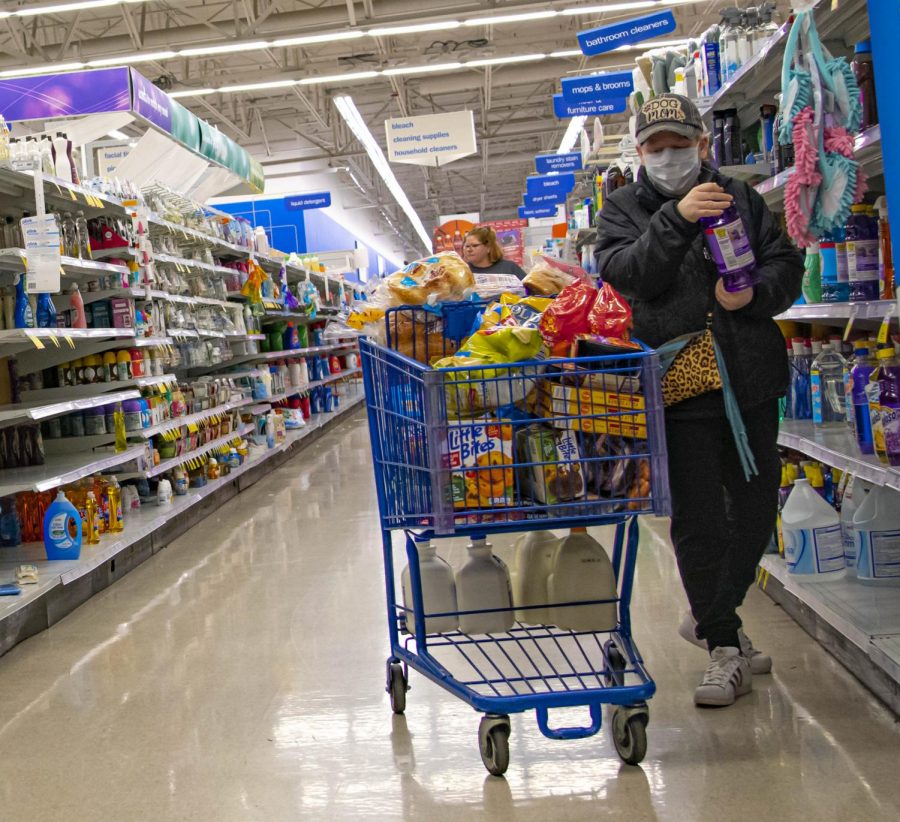 A customer takes precautions while out in public areas on Sunday, Mar. 15, 2020 at Meijer in Springfield, IL 