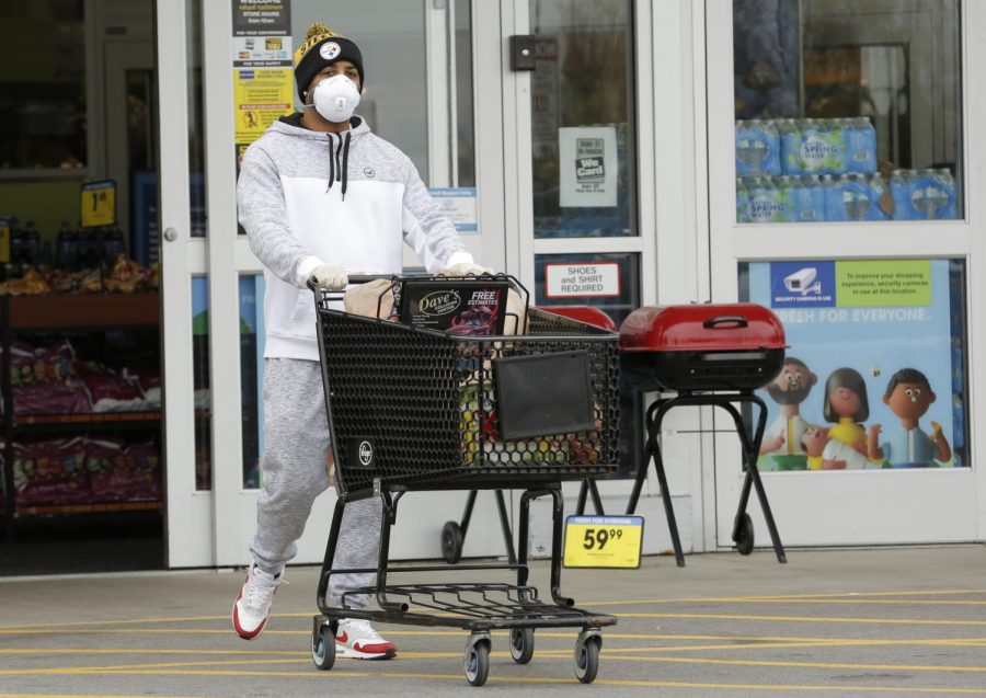 A shopper leaves Kroger supermarket, Carbondale, Illinois, Saturday, April 4, 2020.  Some shoppers opted to wear medical masks to help protect against the Covid-19 pandemic.