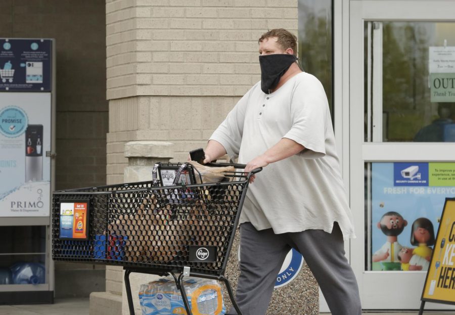 A shopper leaves Kroger supermarket, Carbondale, IL, Saturday, April 4, 2020.  Some shoppers opted to wear homemade medical masks, bandanas, or some other improvised facial covering to help protect against the Covid-19 pandemic.




(Angel Chevrestt, 646.314.3206)
