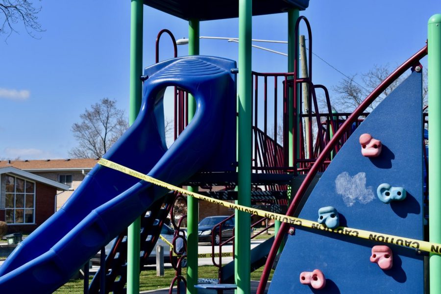 The playground equipment at Ni-Ridge Park in Park Ridge, Illinois is wrapped in caution tape to discourage children from playing. Illinois Executive Order 2020-10 closed all public playgrounds in the state to prevent the spread of COVID-19.  