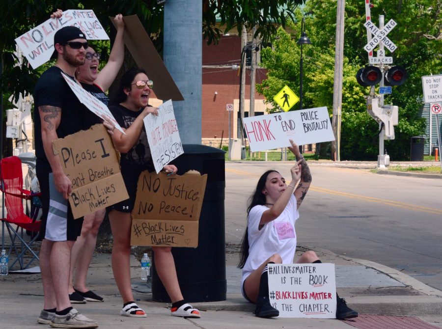 Dylan Lovell, 22, left, Jessica Morrissey, 23, Alexandrea Steven, 21, Cassie Sarcinelli, 21, holding signs during a Black Lives Matter protest in front of Sams cafe, Wednesday, June 3, 2020, in Carbondale, ILL. 