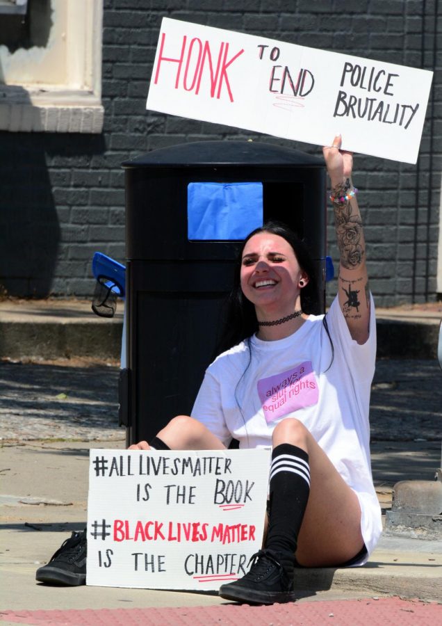 Cassie Sarcinelli, 21, Holds a sign up for cars driving by during a Black Lives Matter protest on the corner of South Illinois Avenue and West College Street, Wednesday, June 3. 2020, in Carbondale, ILL. 