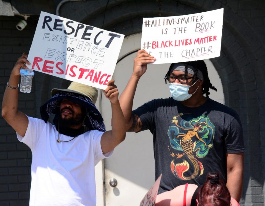 Martell Mosley (left), 23, Tre Knight (right), 23, holding signs during a Black Lives Matter protest in front of Sams Cafe, Wednesday, June 3, 2020, in Carbondale, ILL. 