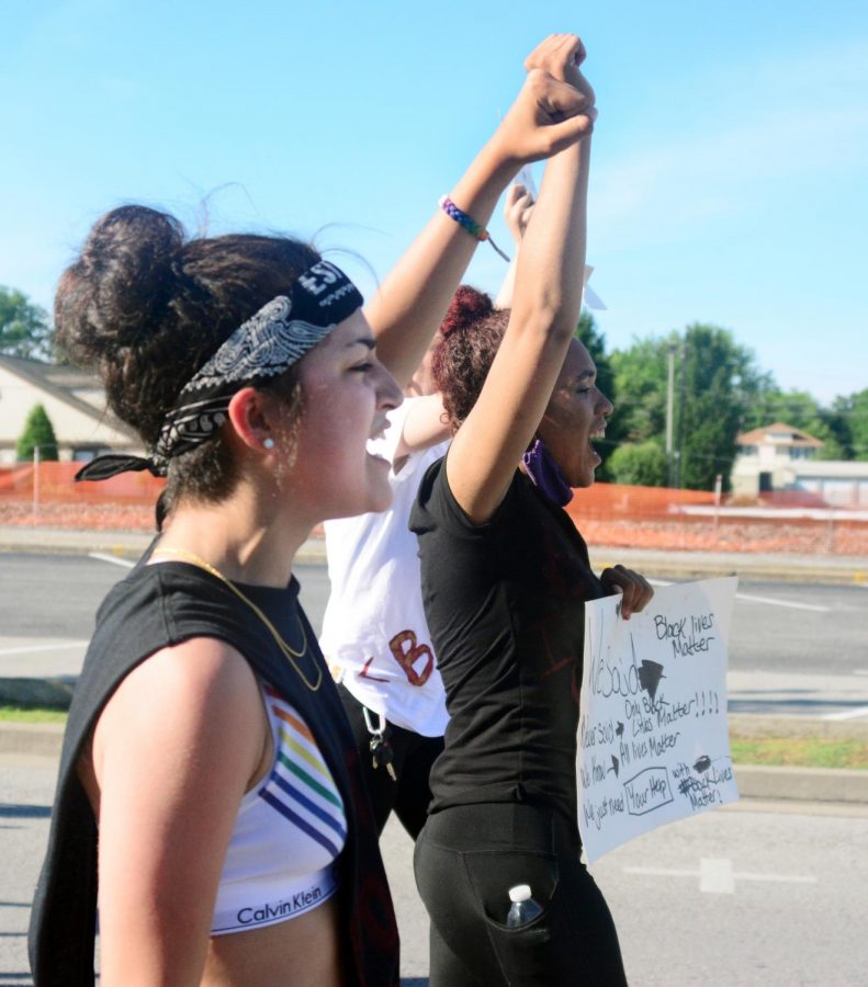 Janet Gomez and Jessica Moore, march together at a Black Lives matter protest, Thursday, June 4, 2020, Anna, IL.