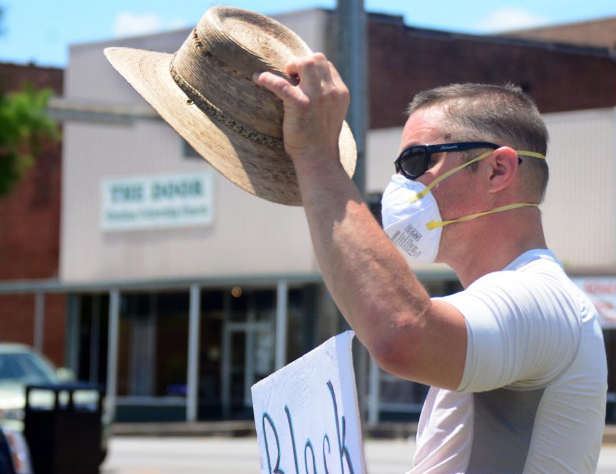 Adam Kaszubski, takes his hat off as cars honk in response to the signs being held by demonstrators at the Peace and Justice monthly vigil held by the Peace Coalition of Southern Illinois, Saturday, June 6, 2020, Carbondale, ILL. 