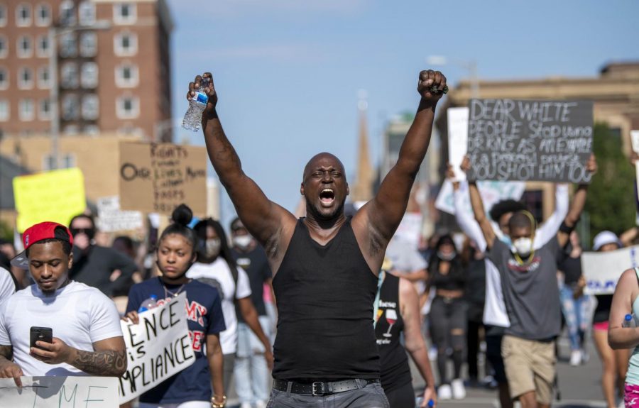 A man puts both hands in the air as he joins in with protestors chants of hands up dont shoot! on Monday, Jun. 1, 2020 in Springfield, IL. 