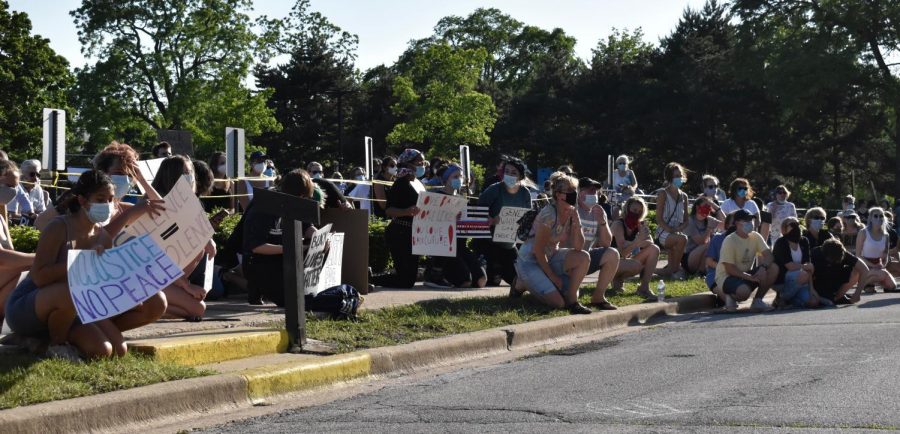 Attendees take a knee, a sign of peaceful protest popularized by former 49ers quarterback, Colin Kaepernick, Tuesday June 2. 2020 in Park Ridge Ill. 

