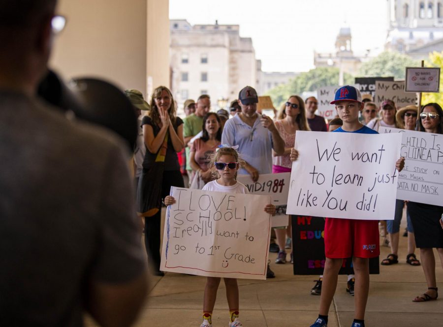 Kids hold signs at the Illinois State Board of Education (ISBE) building as protestors speak about the ISBEs mask guidelines for the schools for the fall semester on Saturday, July 25, 2020 in Springfield, IL. 