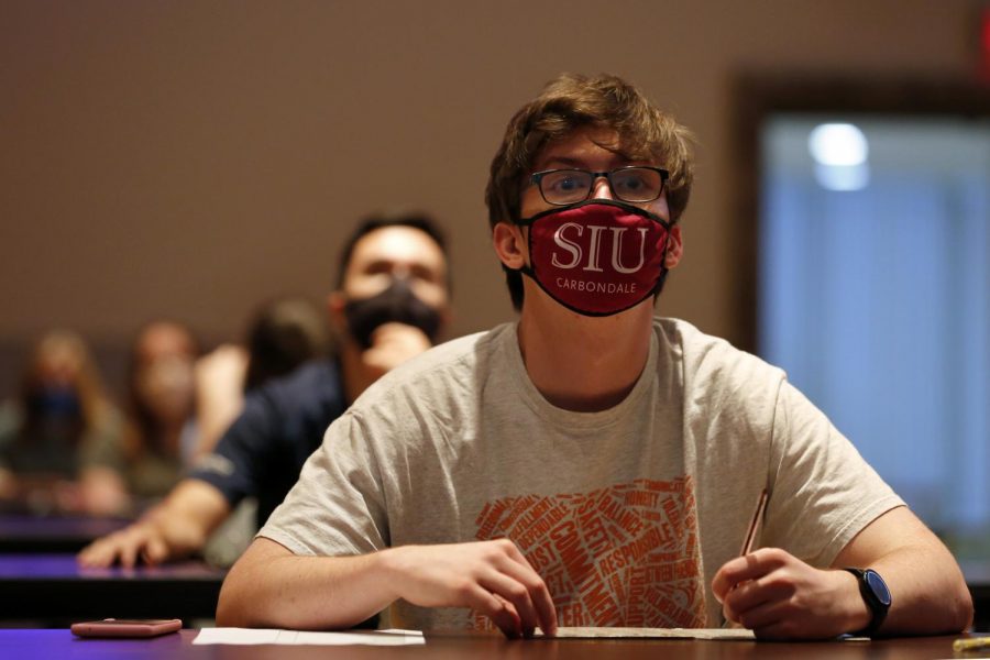 19-yr-old SIU freshman, Ilya Connor looks up at a projection screen that lists the numbers called during a game of bingo at the Student Center, on Saturday, August 22, 2020.
The bingo event, organized by the SIU Student Programming Council (SPC), was limited to 90 students.  In compliance with university guidelines and the state’s Restore Illinois Plan, mask wearing and social distancing were required.  SPC organizers  partitioned the ballroom into two separate rooms; one space allowed for 50 persons, while the other allowed for 40.

Angel Chevrestt // @sobrofotos