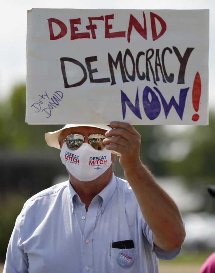 L.P. Rees, 68, of Murphysboro, IL joins a group of about twenty protesters outside the main post office in Carbondale, IL, in solidarity with a nationwide call for a #SaveThePostOfficeSaturday rally on Saturday, August 22 ,2020.
MoveOn, the NAACP, WorkingFamiliesParty, Indivisible and other national organizations announced the nationwide effort to show up at post offices across the country at 11Am on Saturday, August 22, to save the post office from Trump and declare that Postmaster General Louis DeJoy must resign.

Angel Chevrestt // @sobrofotos