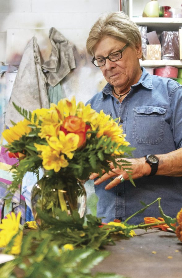 Jerry Brooks arranges flowers into a vase before it goes out on a delivery on Sept. 17, 2020, at Jerry’s Flowers, in Carbondale, ILL.
