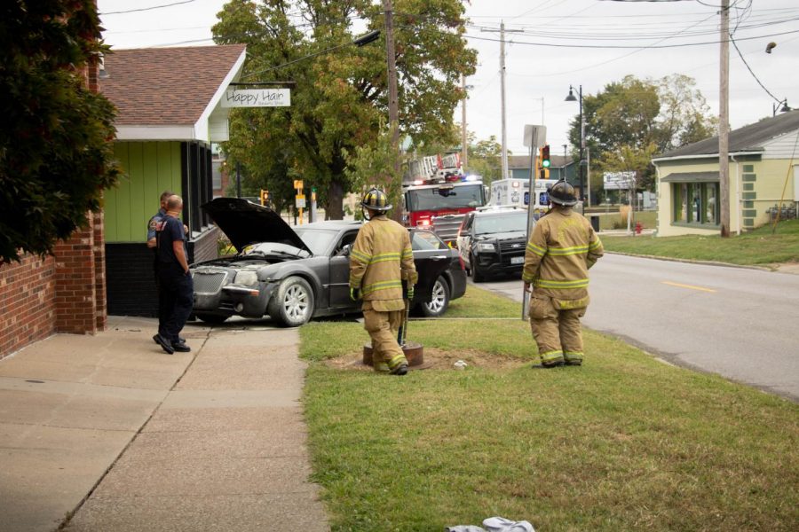 First responders wait for assistance after a car crash near Happy Hair, a beauty shop in Carbondale, IL. on Friday, Sept. 25, 2020.