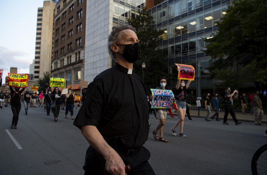 Father Christopher Elwood marches with Black Lives Matter protesters on West Jefferson St. in downtown Louisville, Ky. on Sept 26 in protest of the grand jury decision in the Breonna Taylor case. The institutions of government, the institutions of police, have been not living into compassion and love and justice,  Elwood said. The clergy have come out to represent that commitment to justice. The commitment to faith to care for those who are suffering. To care for those who are brutalized. Its a time when our faith calls us to be in the streets and with the people.