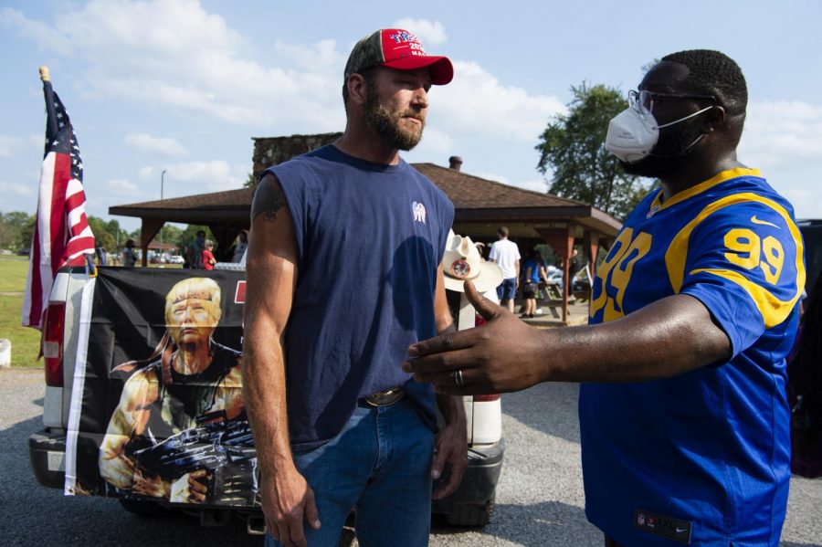 Jeff Messemore, left, and Ayo Oyetunji speak together after the Black Lives Matter march through City Park in Vienna, Ill. on Sept. 27. 