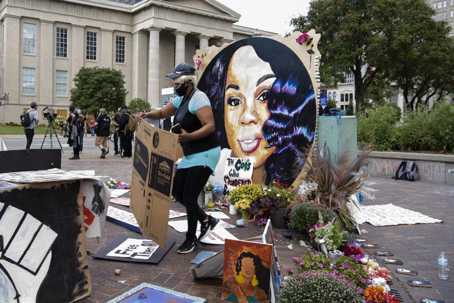 Leah Sallis looks to add a piece to the growing memorial to Breonna Taylor in Jefferson Square park in Louisville, Ky. on Sept. 25. 