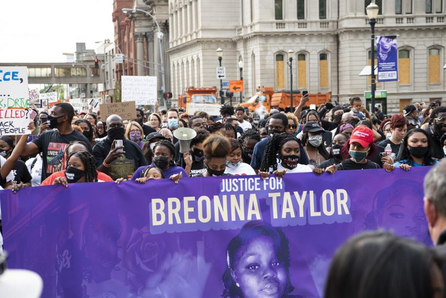 Protesters of the grand jurys decision in the death of Breonna Taylor carry a sign in her memory during a march through Louisville, Ky. on Sept. 25.  
