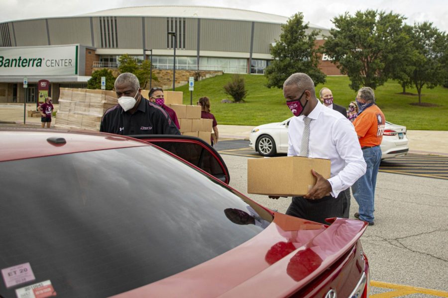 SIU Chancellor, Austin Lane, helps load produce  into peoples cars during the Pandemic Relief Food Distribution event in front of the Banterra Center. Produce was donated by Cusumanos & Sons for people who have hit hard by the pandemic on Thursday, Sept. 3, 2020 at SIU. 