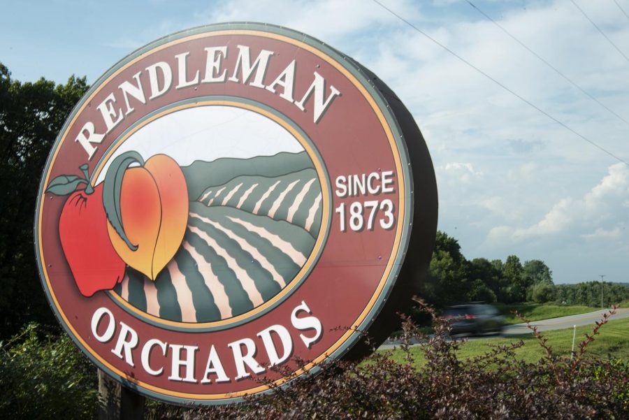 A car passes behind the Rendlemans Orchard sign located on Illinois Route 127 in Alto Pass on Sept. 12. Rendlemans offers flower fields to walk through, goats and chickens to pet and apples for sale through the fall season. 