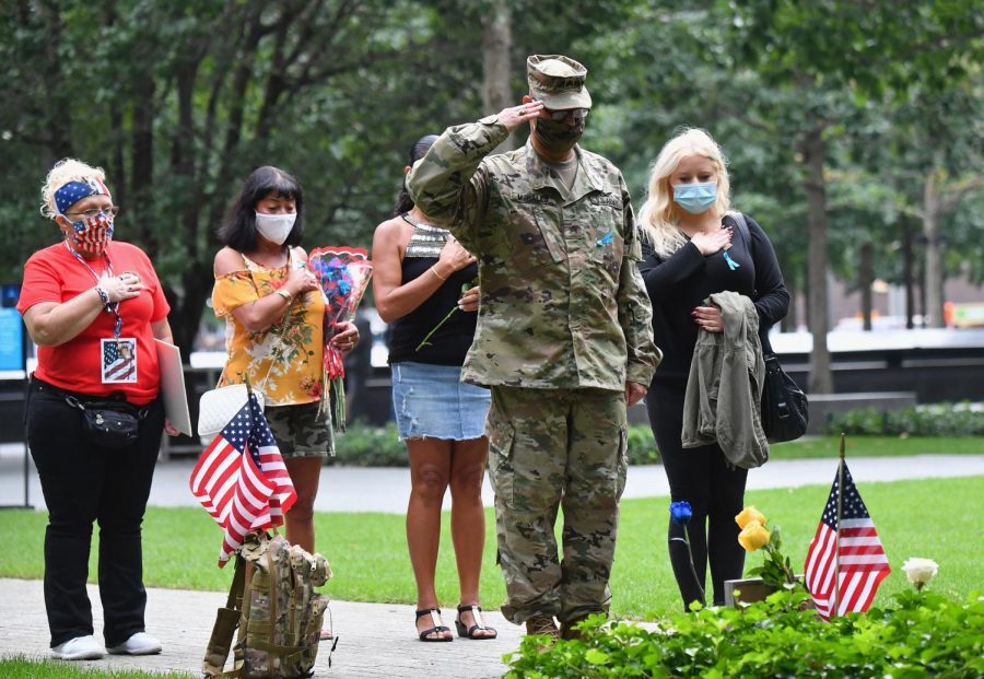 Family members pay their respects to victims of the 9/11 attacks during the 19th anniversary commemoration ceremony at the 9/11 Memorial on Sept. 11, 2020, in New York City.