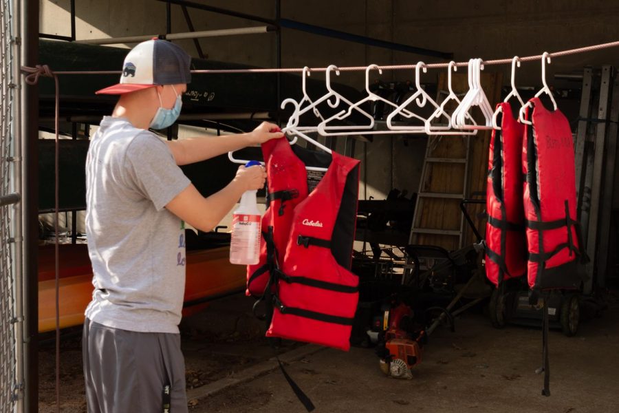 Durley Thomas, 21, cleans up a life vest after being returned at Base Camp inside of
the Student Recreation Center on Monday, Sept. 14, 2020.