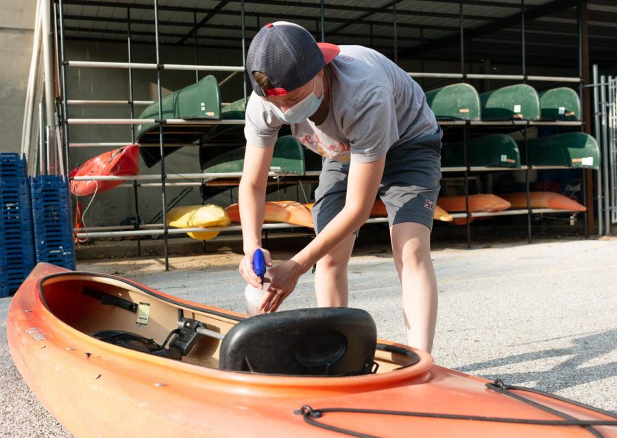 Durley Thomas, 21, cleaning up a kayak after being returned at Base Camp inside of the
Student Recreation Center on Monday, Sept. 14, 2020.