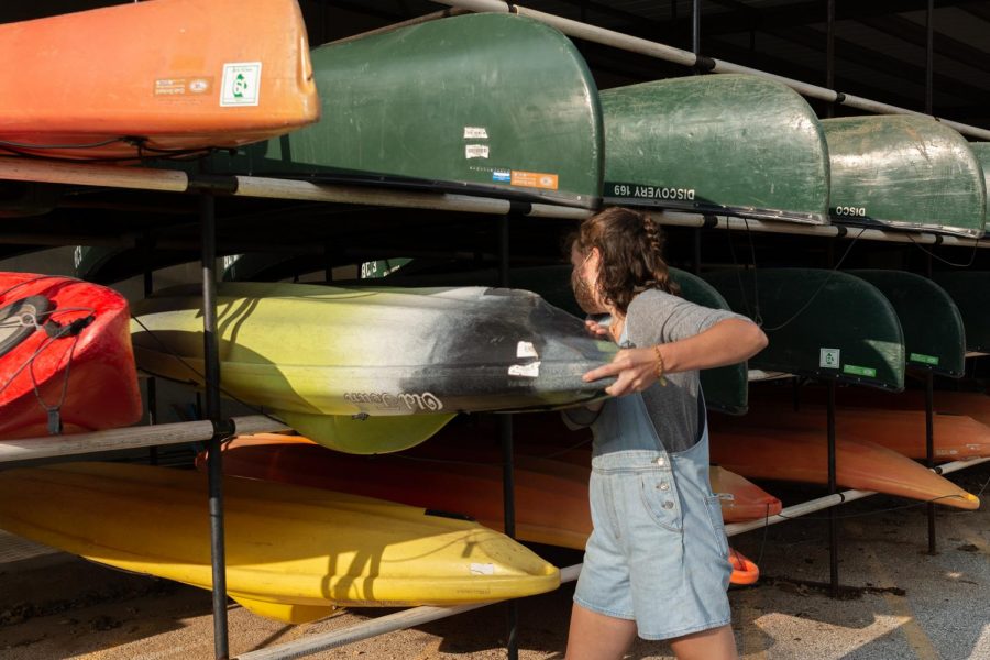 Sydney Pogue, 23, fixes a kayak, one of the most rented items at Base Camp on Monday, Sept. 14, 2020.