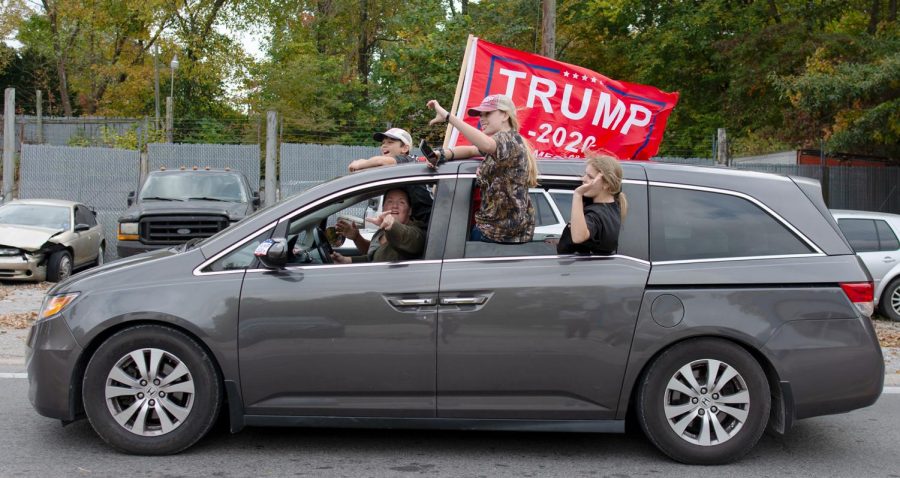 Trump supporters wave during the Trump Train on Saturday, Oct. 10, 2020, in Cobden, Ill.