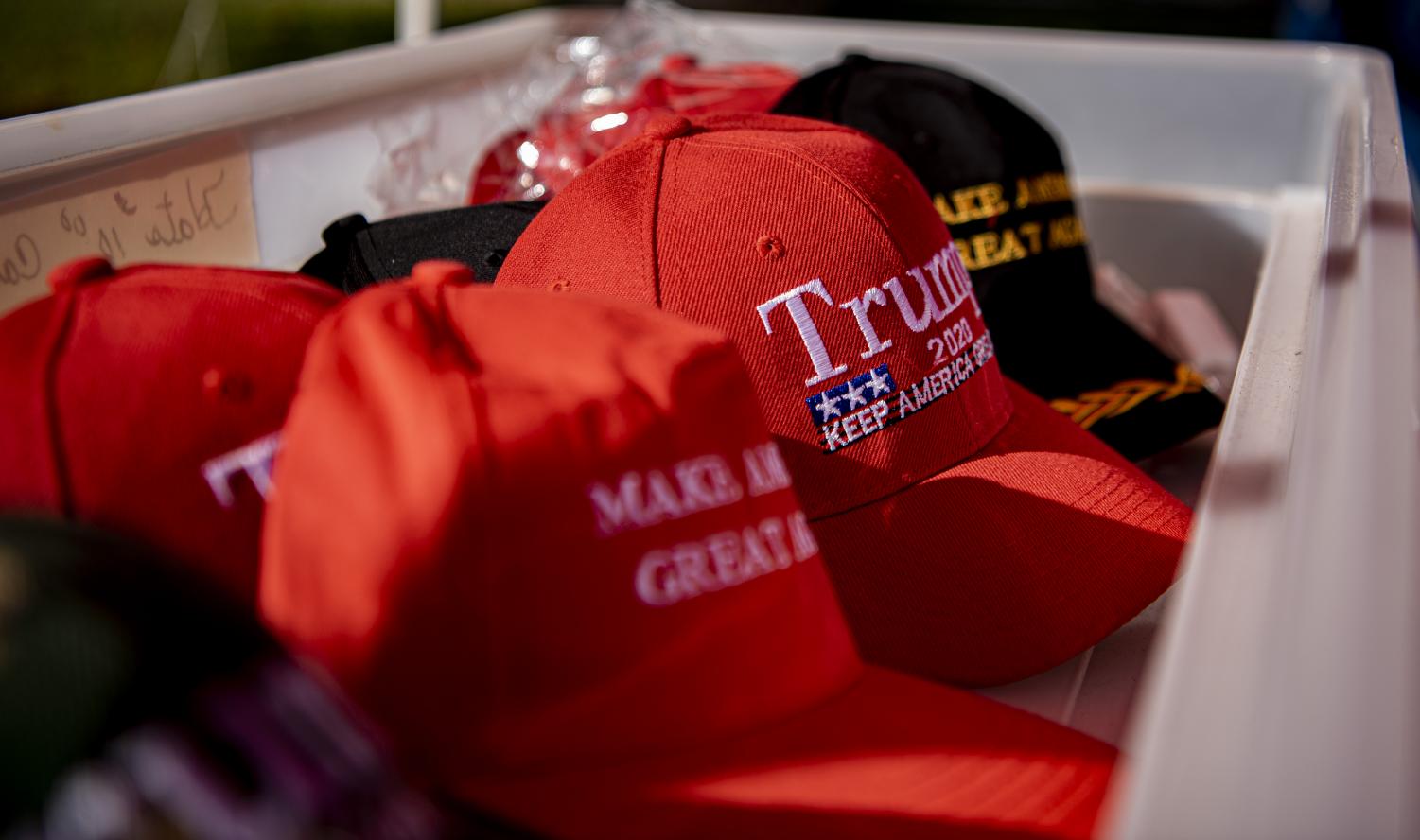 Trump hats sit in a bin at Doris Millers Trump merchandise stand in Vienna, Ill. An avid Trump supporter, Miller sells Trump merchandise to raise profits for Trump. We don’t even take our lunch money out of that, because we want every cent to go to Trump, Miller said Saturday, Oct. 17, 2020. 