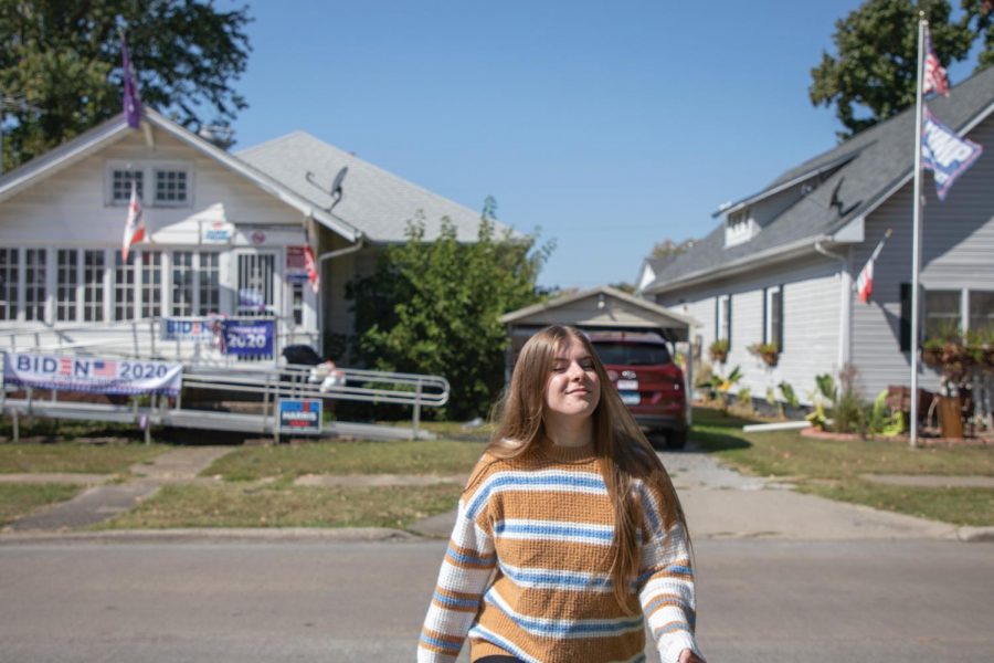 John A. Logan College freshman, Abigail Wheatley, walks near several Trump and Biden flags  Wednesday, Oct. 7, 2020, in Herrin, Ill. Although Wheatley is 18, she is not voting in the upcoming presidential election. She believes whoever wins won’t fulfill their promises in office. 
