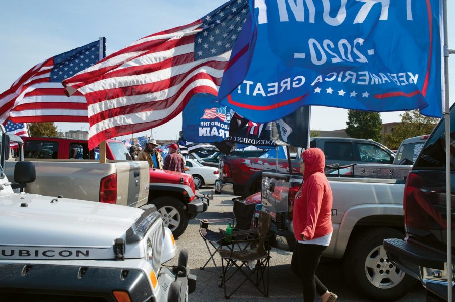 Trump flags fly on cars at a parking lot in Marion, Ill. at the Trump Train Saturday, Oct. 17, 2020, in  Carbondale, Ill.