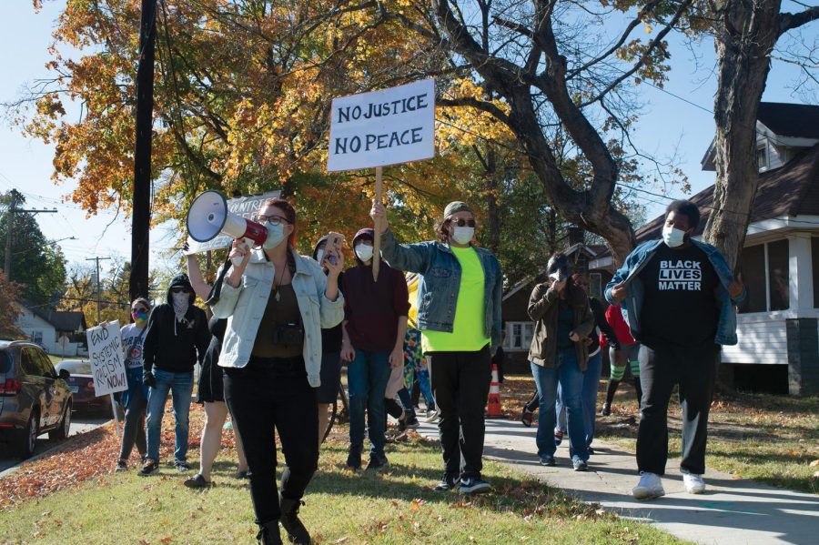 Protestors march down a street in Carbondale, Ill. chanting “Black Lives Matter” in a counter-protest to the passing Trump supporters Saturday, Oct. 17, 2020, in  Carbondale, Ill.