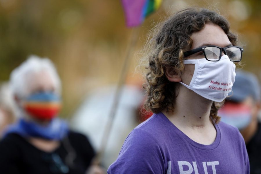 SIU student Liam Reinier, 18, of West Des Moines, Iowa, listens to a speaker during a rally against the status quo in American politics, organized by various local activist groups on the day after the election, Wednesday, November 4, 2020, in Carbondale, IL.