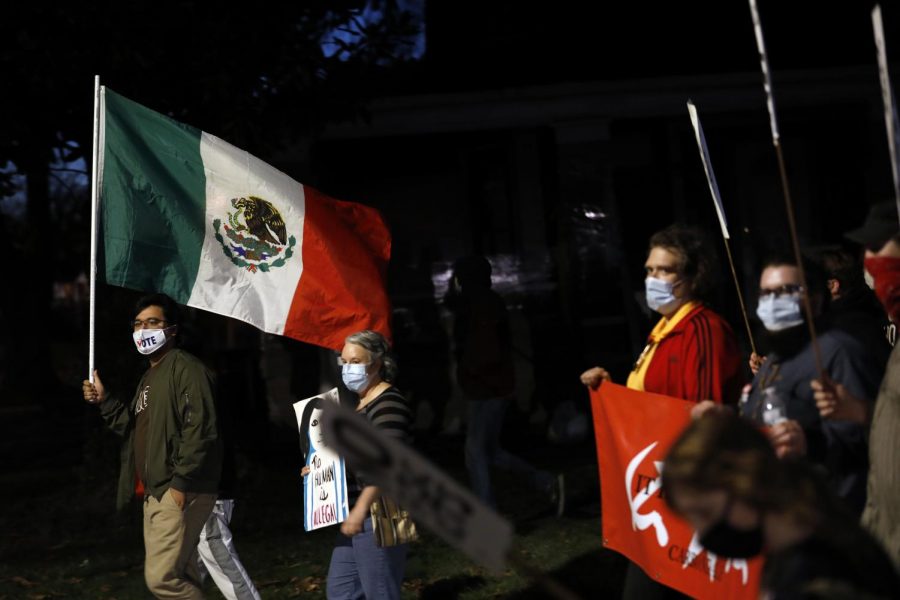 SIU Cinema and Advertising student, Tómas Cortez, carries a Mexican flag as he marches with members of local activist groups to protest against the status quo in American politics on the day after the election, Wednesday, November 4, 2020, in Carbondale, IL.  Cortez, 21, and the group of around 40 protesters marched from the town square pavilion to the US General Services Administration building and then back to the pavilion.  Im here to show that even if Biden wins we still have a lot of issues to cover and so we do need to bring awareness not only to conservatives but also to progressives as well, said Cortez.