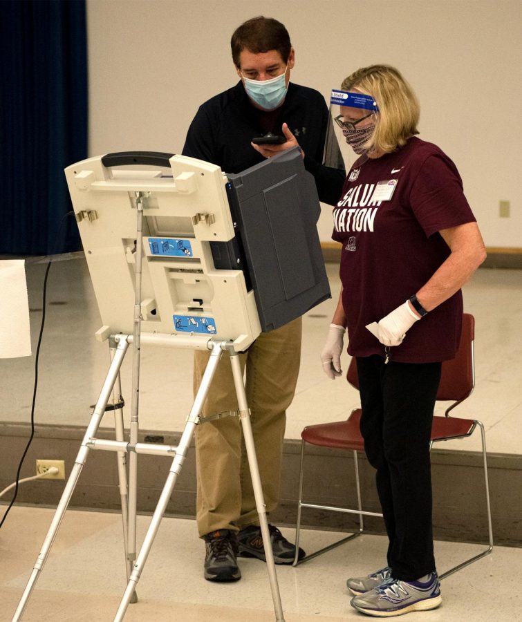 County clerk Frank Byrd (left) and Nancy Faeger (right) attempt to fix the polling machines for non-registered voters Tuesday, November 3, 2020, in Carbondale, ILL. As the polls opened at the Carbondale Civic Center, poll workers were alarmed when the machines displayed election material and code from the last presidential election. Having originally been held at SIU the machines had to be reset in order to be properly used for voters, causing a delay of over an hour. Voters were urged to come back at a later time or to stand and wait, resulting in several voters leaving in frustration. 