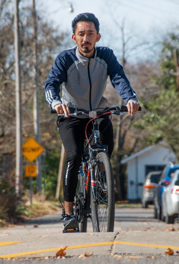 Pradip Acharya, an international student in the Department of Mechanical Engineering, rides his bike in the morning on Friday, Nov. 13, 2020, in Carbondale, Ill. “I used to go to the Rec Center regularly for exercise, but since COVID-19, I do not feel safe to go to the Rec Center. I find cycling a very good exercise and enjoy it in the early morning. COVID-19 has messed up our life, but I feel health is more important above all the hurdles. I hope everything will be fine in the end,” Acharya said.