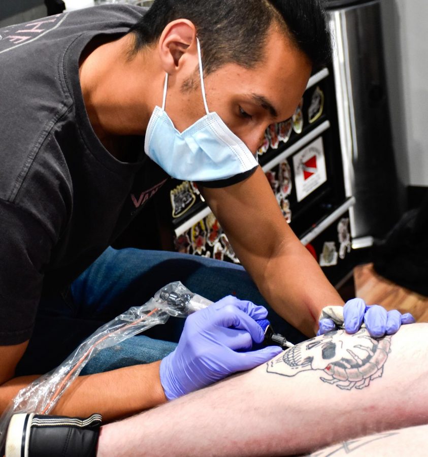 Fernando Sanchez, a senior majoring in art, works on a tattoo Nov. 4, 2020, in Carbondale Ill. Sanchez said that he originally started as an engineering major but decided to study drawing instead. “I view this as another art form because at school I’m a fine artist. It’s a really nice opportunity to challenge myself with another type of canvas but still sustain myself as an artist,” Sanchez said.