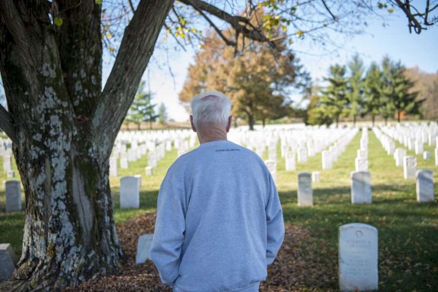 Kenny Johnson, a retired Air Force veteran, looks upon a grave at Mound City National Cemetery during Veterans Day on Wednesday, Nov. 11, 2020 in Mound City, Ill. Johnson has only been coming to the cemetery for the last couple of years, but says he finds it to be a peaceful place to go and walk down row by row, reading information from soldiers tombstones.